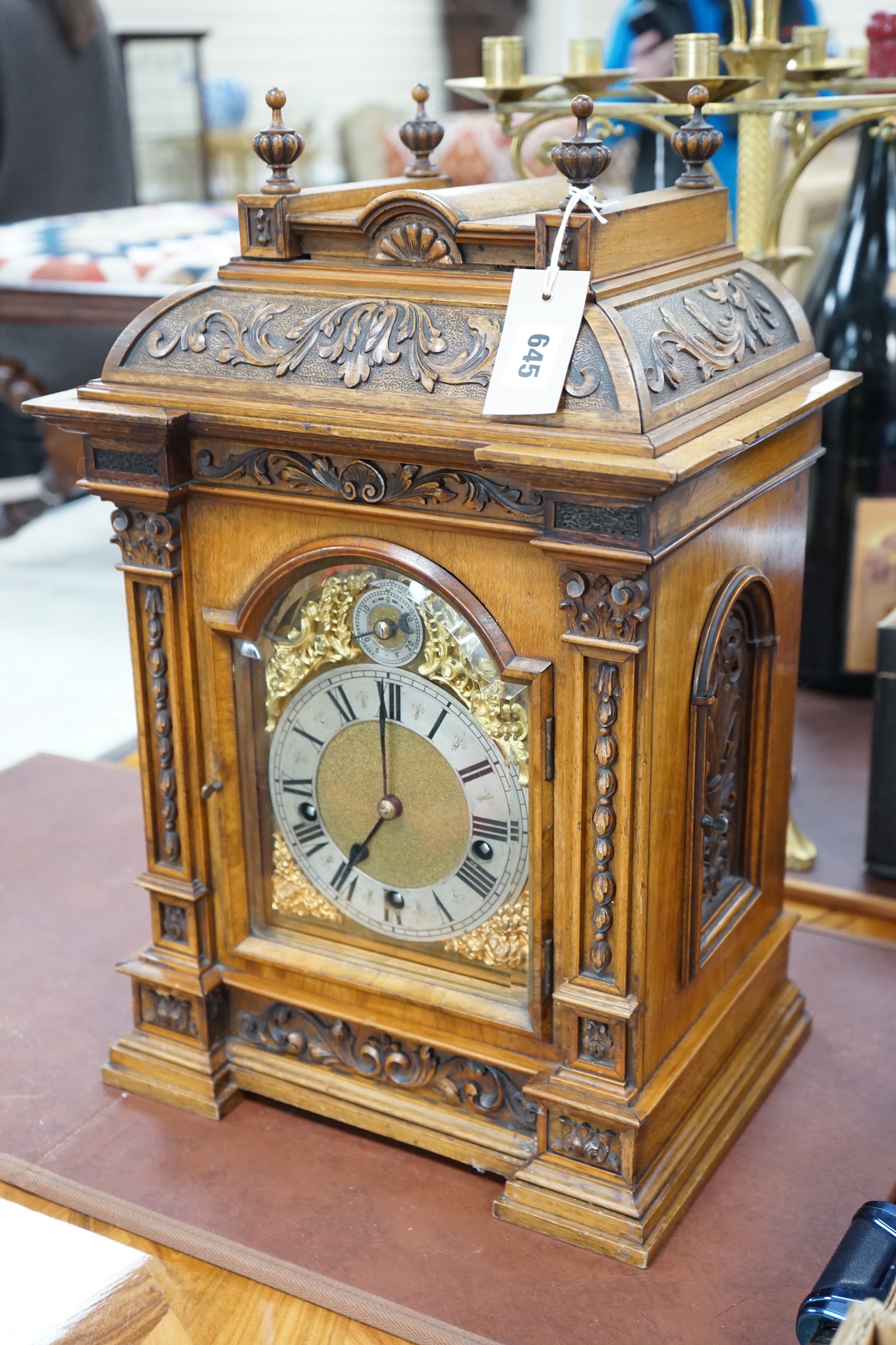 A 19th century architectural walnut bracket clock, with key and pendulum. 53cm tall